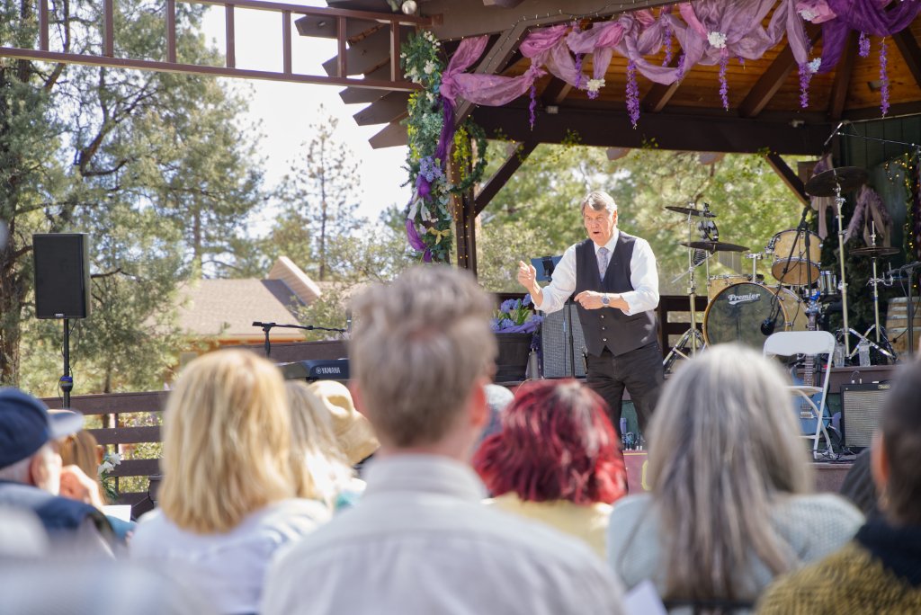Pastor John Saltee preaching on stage at the Pine Mountain Club community center on Easter Sunday.